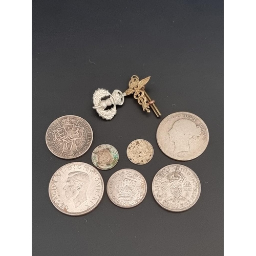 133 - Coins: seven UK silver and part silver Victorian and later coins; together with two military badges.... 