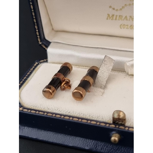 464 - A cased pair of 9ct gold and onyx cylinder cufflinks, by W H M, Birmingham 1999, 21mm long.... 