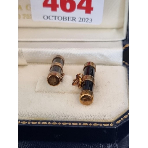 464 - A cased pair of 9ct gold and onyx cylinder cufflinks, by W H M, Birmingham 1999, 21mm long.... 