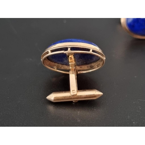 472 - A pair of yellow metal and lapis lazuli cufflinks, stamped 14k.