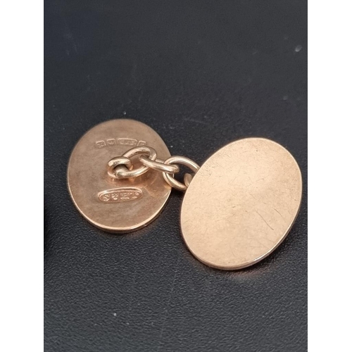 473 - A pair of 9ct gold oval cufflinks, with chain connectors, 10.8g