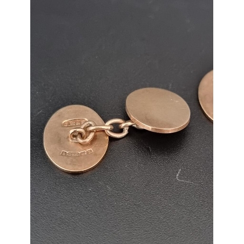 473 - A pair of 9ct gold oval cufflinks, with chain connectors, 10.8g