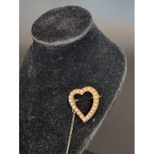 486 - An Edwardian yellow metal pearl set open heart shaped brooch, 2.5cm high.