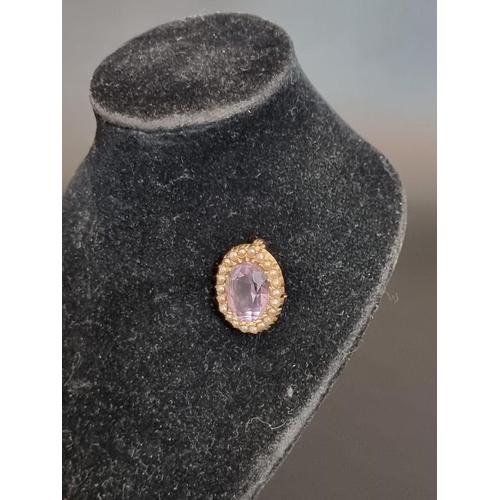 488 - An amethyst and pearl oval brooch, stamped 15ct, 2cm.