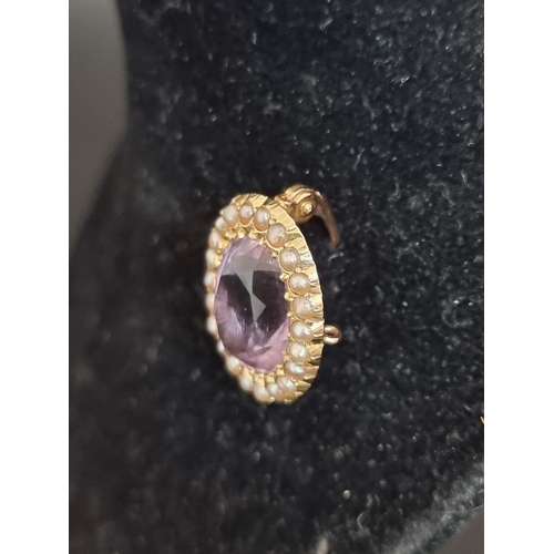 488 - An amethyst and pearl oval brooch, stamped 15ct, 2cm.