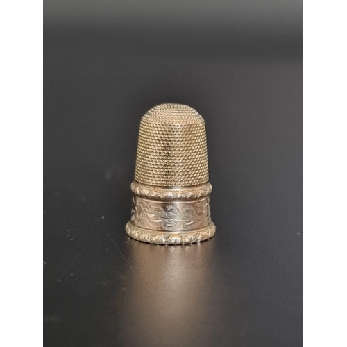 493 - A yellow metal thimble, 2.5cm high.