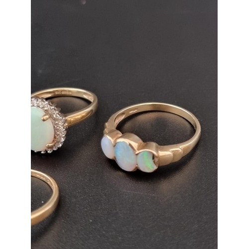 499 - A 14ct gold opal set ring; together with three 9ct gold opal set rings. (4)