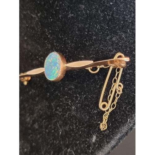 500 - A yellow metal and opal bar brooch, 50mm.