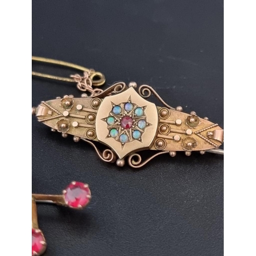 510 - A 9ct gold brooch, set central ruby surrounded by eight cabochon opals, 4.3cm, gross weight 4.8g; to... 