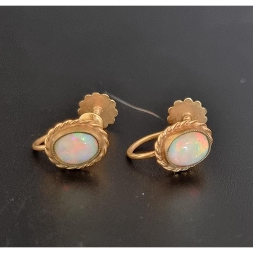 512 - A pair of yellow metal and opal screw back earrings, stamped 9ct.