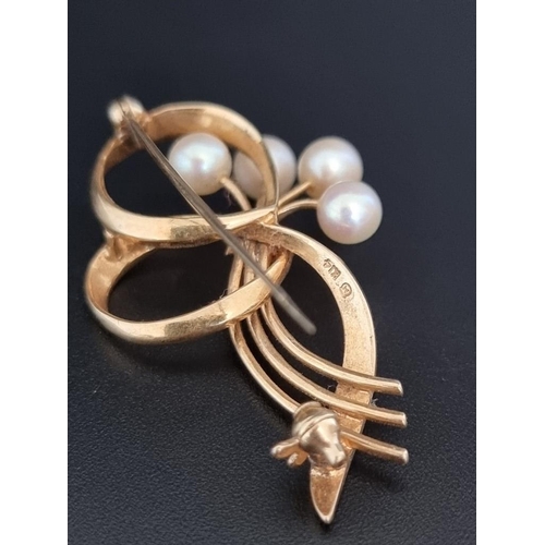 514 - A floral spray bar brooch set four pearls, stamped 14k, 42mm; together with a ring, with seven attac... 