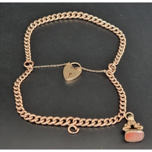 520 - A yellow metal curb chain, each link stamped 9c, 15cm, with a 9ct gold padlock clasp and attached me... 