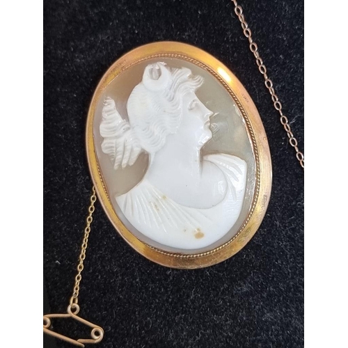 521 - A 9ct gold carved shell cameo, 5.2cm high; together two other items, stamped 9ct. (3)... 