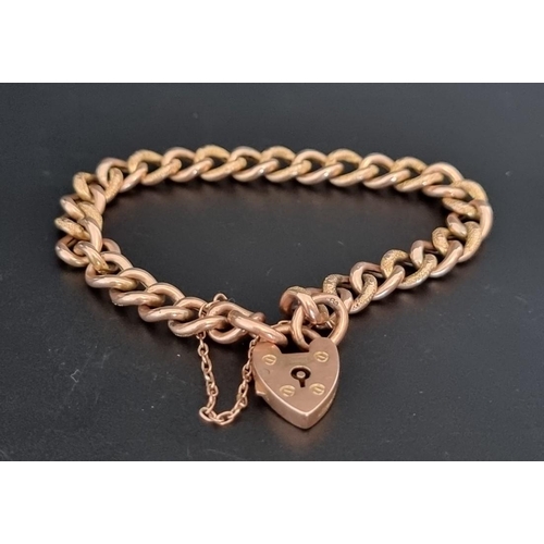 526 - A yellow metal hollow curb link bracelet, with padlock clasp, stamped 9c