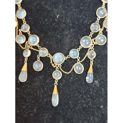 527 - A vintage yellow metal moonstone fringe necklace, 41cm.