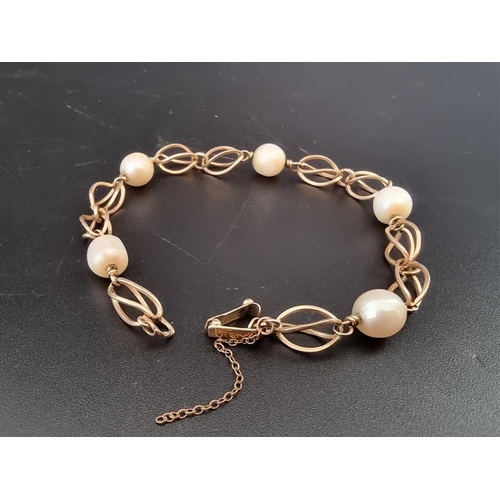 542 - A vintage yellow metal fancy link bracelet, having five interspersed pearls, 20cm.