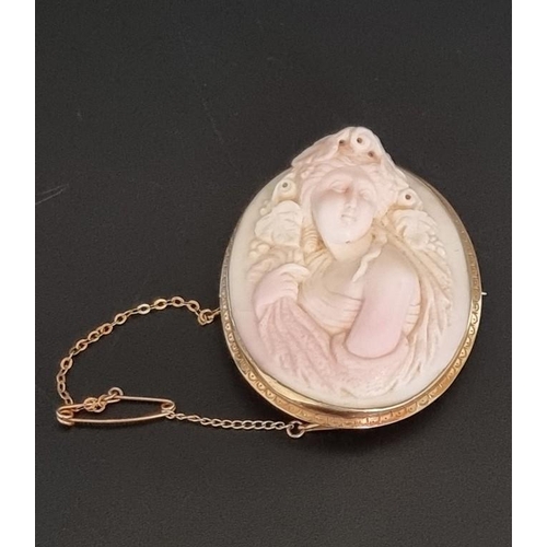 555 - A 19th century carved hardstone cameo carved a Bacchante, in unusually high relief, in a yellow meta... 