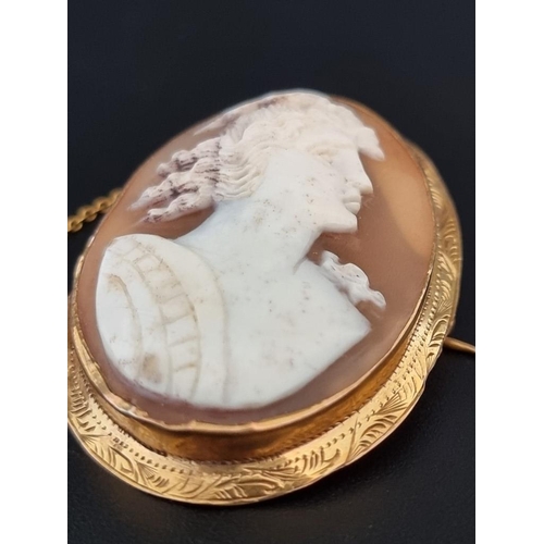 557 - A yellow metal carved shell cameo, in a yellow metal mount, 46mm high; together with another similar... 