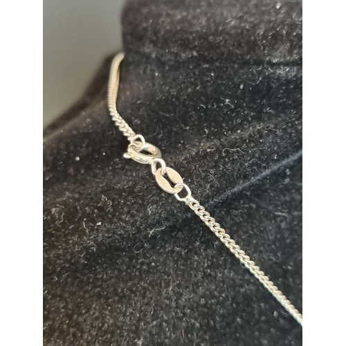 572 - A silver heart pendant, on a white metal necklace chain stamped '935'.