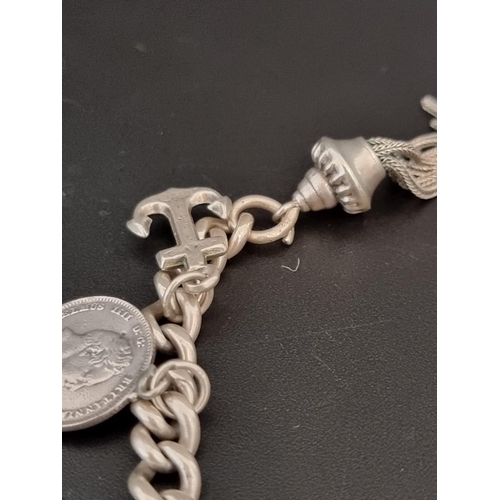 575 - A white metal curb link charm bracelet, with nine charms.