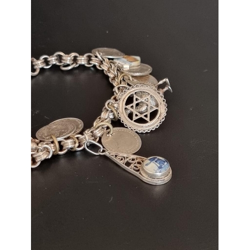 582 - Two white metal charm bracelets, with multiple attached .800, sterling and other charms. (2)... 