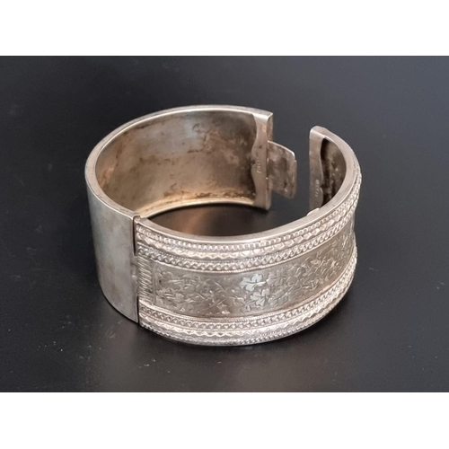 585 - A hinged bangle, stamped 'Silver'.