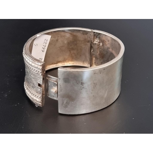 585 - A hinged bangle, stamped 'Silver'.