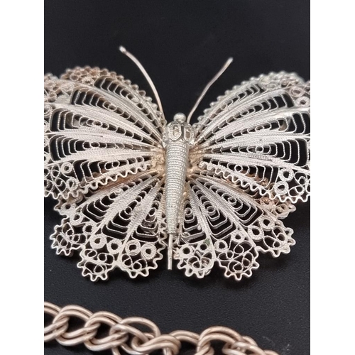 587 - A filigree butterfly brooch; together with a silver pencil holder; a silver bracelet; and a cameo br... 