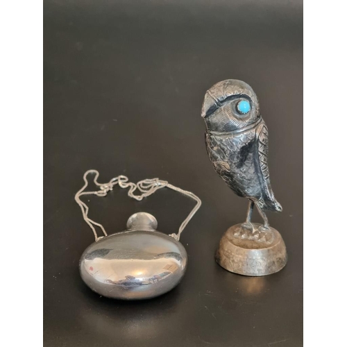 590 - A necklace, stamped 925, with attached flask, 63mm high; together with a model of an owl, on later a... 