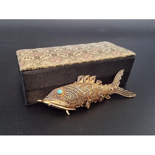 597 - A Chinese articulated silver gilt and fish pendant, having turquoise set eyes, 7cm, boxed.... 