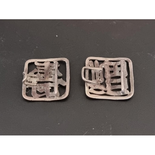 600 - A pair of Chinese metal buckles, decorated characters within a stylised bamboo frame, 4.5cm.... 