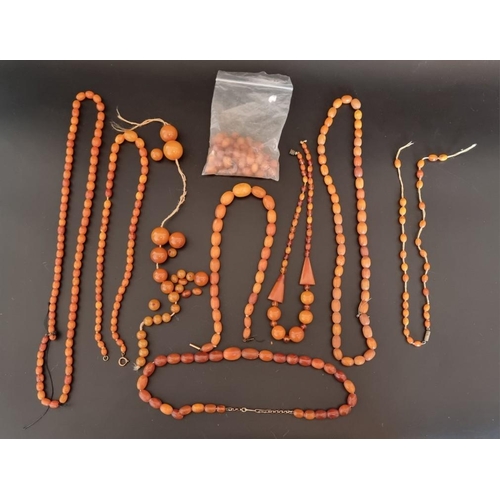 610 - Six amber bead necklaces; together with a quantity of amber beads.