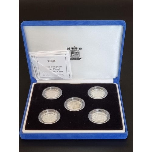 77 - Coins: a Royal Mint silver proof 'One Pound Coin Collection', containing five coins dated 2001-5, ea... 