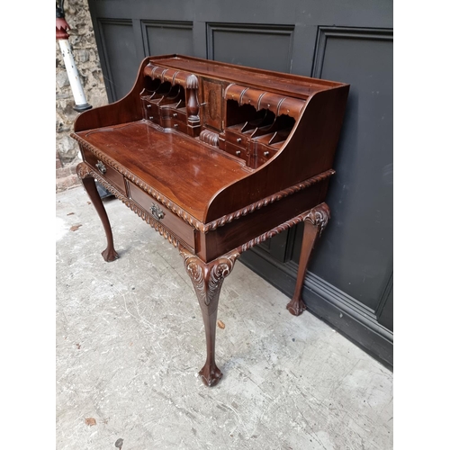 1067 - Au unusual reproduction carved mahogany desk, 103.5cm wide.