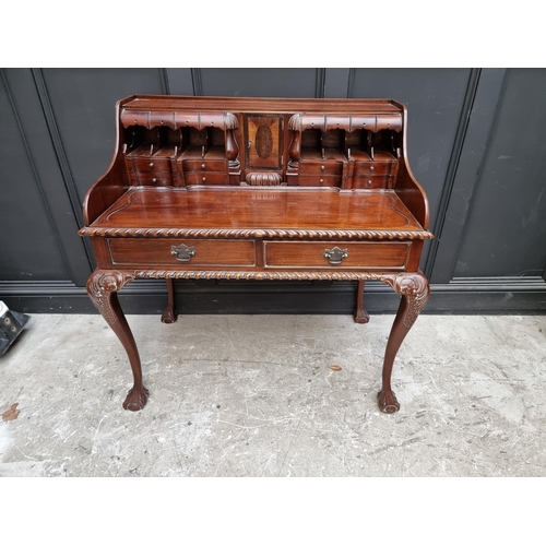 1067 - Au unusual reproduction carved mahogany desk, 103.5cm wide.