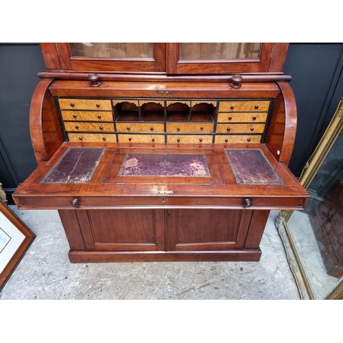 1002 - A Victorian mahogany cylinder bureau bookcase, with sliding and ratcheted surface, 117cm wide. ... 