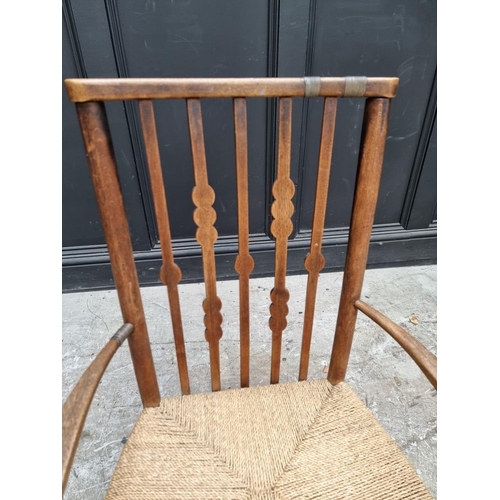 1080 - A Liberty style beech and rush elbow chair, in the manner of Morris & Co. 