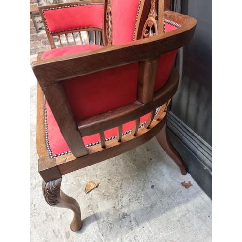 1085 - A circa 1900 carved mahogany and brass studded red suede settee, 124cm wide.