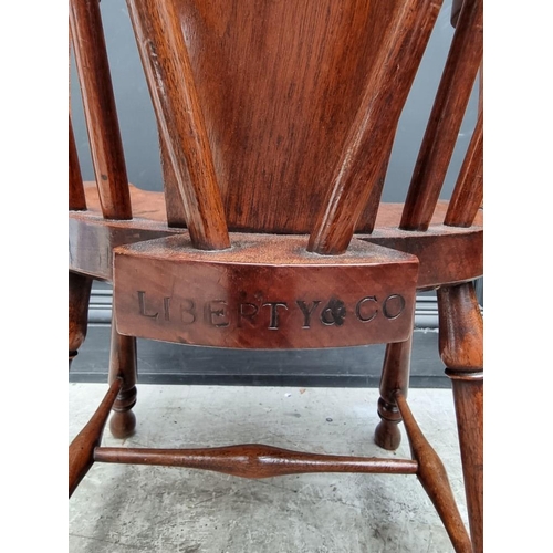 1088 - An unusual circa 1900 mahogany elbow chair, stamped 'Liberty & Co'. 