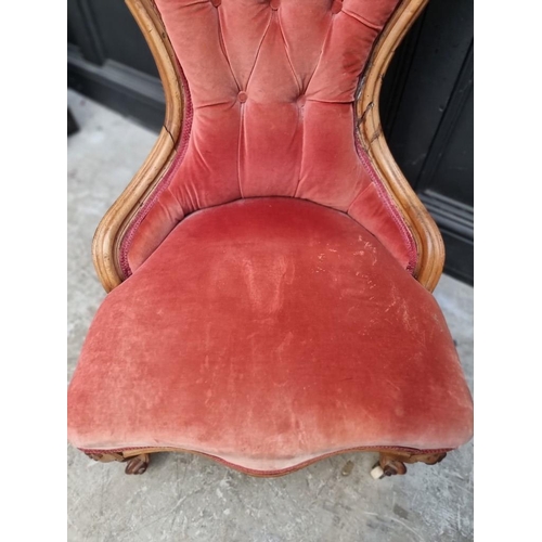 1090 - A Victorian walnut and button upholstered nursing chair. 