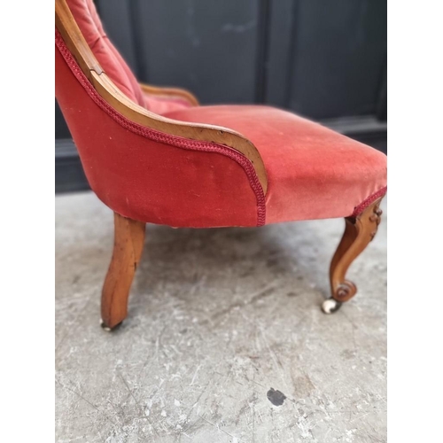 1090 - A Victorian walnut and button upholstered nursing chair. 