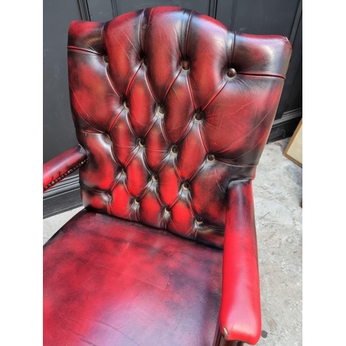 1095 - A reproduction leather revolving desk chair. 