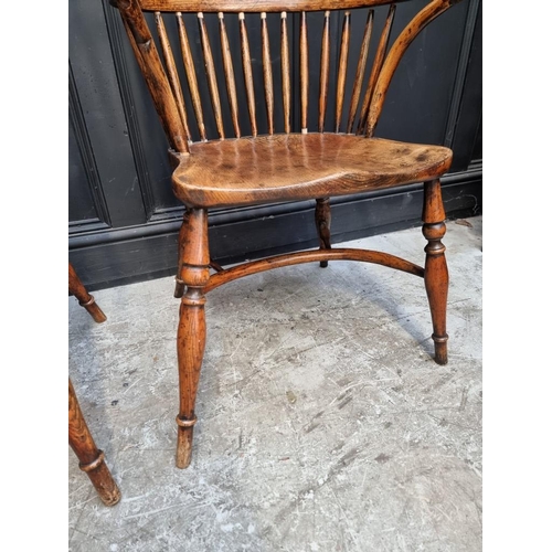 1096 - A pair of ash and elm Windsor armchairs, each with crinoline stretcher, (variations to heights of ba... 