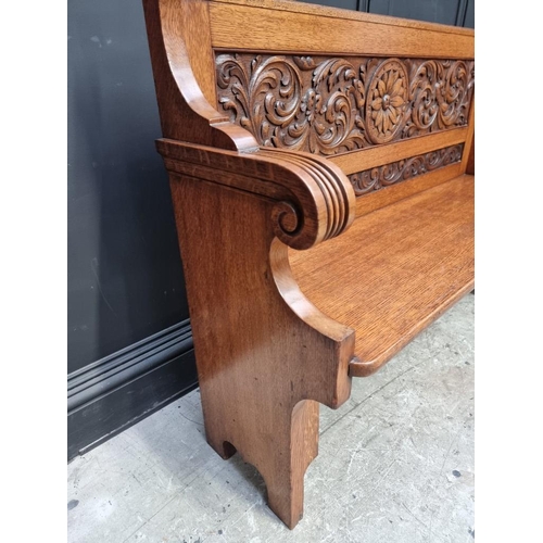 1101 - An early 20th century carved oak settle, 125cm wide.