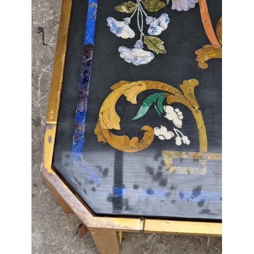 1103 - A large slate and pietra dura table top, 105cm wide, on lacquered brass low stand, (shallow chi... 