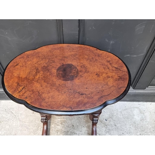 1041 - A Victorian burr walnut and ebonized oval occasional table, 67cm wide. 