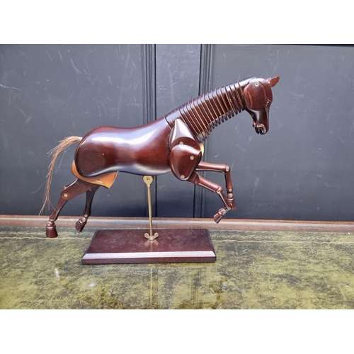 1155 - A reproduction stained wood articulated horse, 31.5cm high.