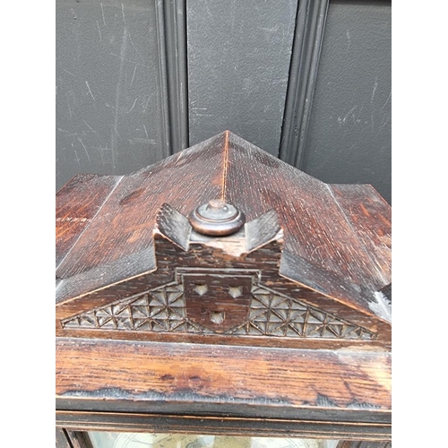 1163 - An oak mantel clock, striking on two gongs, 32.5cm high, with pendulum. 