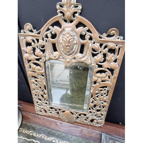 1166 - A cast brass framed mirror, 38 x 24.5cm; together with an electroplated Corinthian column table lamp... 