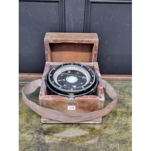 1175 - A ship's gimbal compass, in wood case with broad arrow stamp, 26cm wide.